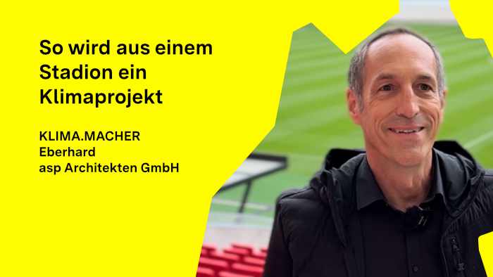 Eberhard Becker steht in den Sitzreihen der MHP Arena, lächelt in die Kamera – im Stadion fanden EM-Spiele statt.